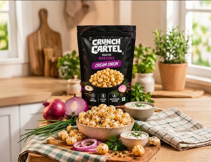Crunch Cartel Cream & Onion pack with a bowl of makhana, onions and dip in a kitchen setting